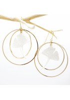 Ginko leaf earring framed by two gold-plated hoop earrings