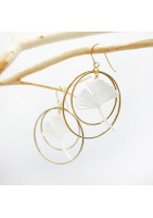 Ginko leaf earring framed by two gold-plated hoop earrings