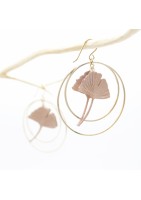 Ginko leaf earring framed by two gold-plated hoop earrings