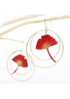 Ginko leaf earring framed by two gold-plated hoop earrings