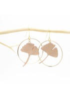 Ginko leaf earring framed by two gold-plated hoop earrings