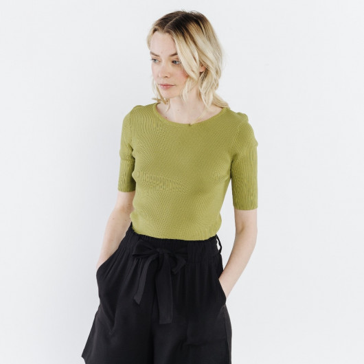 Small lime green sweater, with short knit sleeves, lined with a ribbon tied on the back
