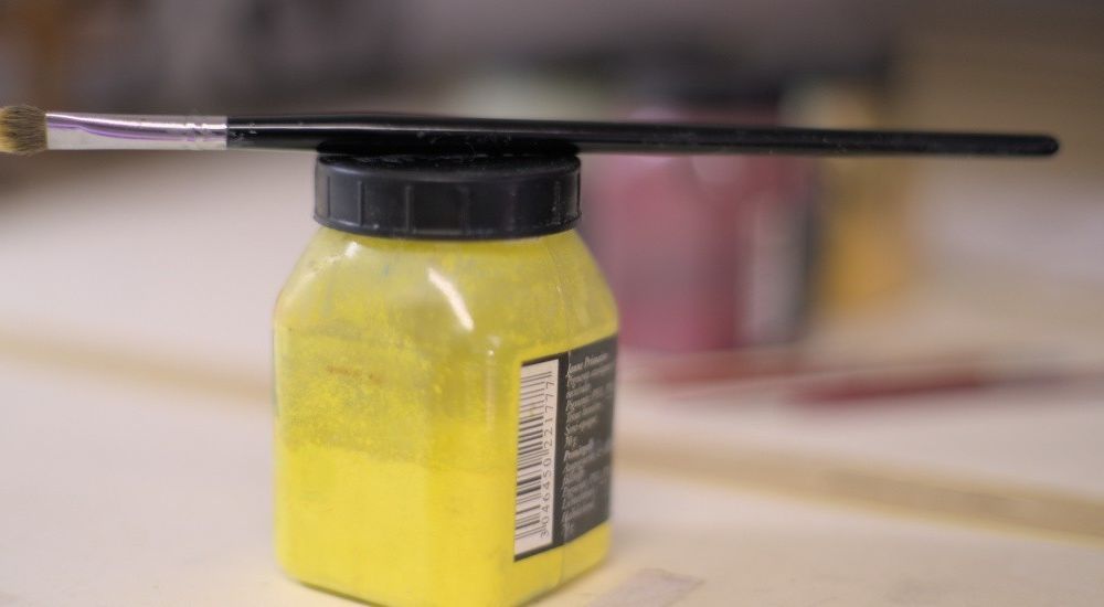 Pot de peinture et son pinceau.