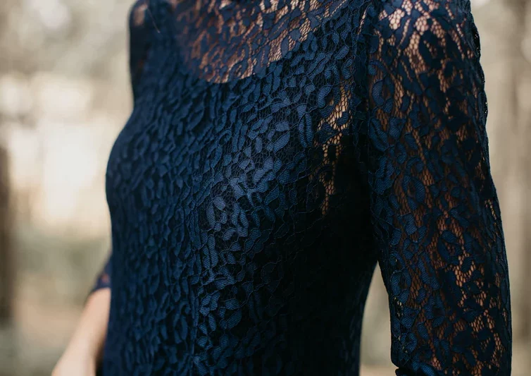 Long evening dress in navy lace and low back neckline